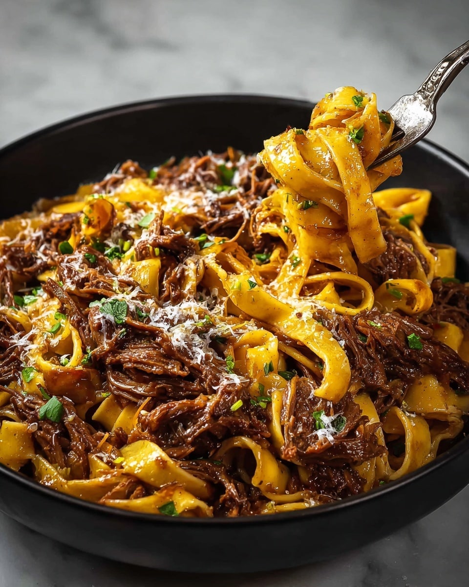 A close-up of a black bowl filled with three layers of thick, flat yellow pasta noodles mixed with tender, dark brown shredded meat. The noodles and meat are coated in a rich sauce, with small bits of chopped green herbs scattered on top, and sprinkled with white grated cheese. A fork lifting a twirled portion of noodles and meat is on the right side of the bowl. The bowl is set on a white marbled surface. Photo taken with an iphone --ar 4:5 --v 7