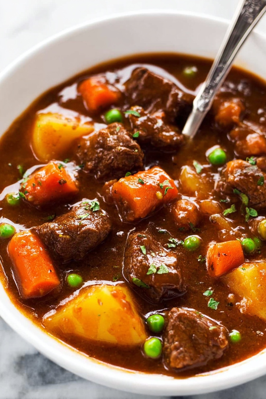 This image shows a thick brown stew filled with several pieces of tender beef, bright orange carrot chunks, and a few green peas scattered throughout. The stew has a rich, smooth, and slightly glossy sauce that coats the meat and vegetables evenly. A large metal ladle in the center lifts a portion of the stew, highlighting the chunky texture of the ingredients and the thick, savory gravy dripping slowly. The background is a white marbled surface. photo taken with an iphone --ar 2:3 --v 7 - Slow Cooker Beef Stew, hearty beef stew, easy slow cooker recipes, comforting meal ideas, tender beef stew