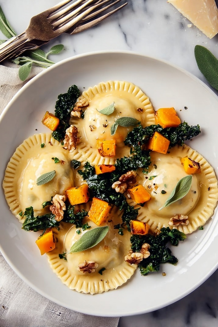 Two white plates on a white marbled surface each hold three large ravioli pieces. The ravioli are light yellow with crimped edges, placed over dark green cooked kale leaves. Small, bright orange cubes of roasted squash are scattered on top along with a few light brown walnut pieces. Fresh green sage leaves and tiny thyme leaves are sprinkled over the dish. One plate has a black-handled fork and a silver knife resting on it, while another fork with a beige handle lies on the surface nearby. To the left, a small wooden dish holds extra walnuts, next to two glass jars—one with olive oil and one with white vinegar. Fresh sage sprigs and a blue cloth napkin are around the plates. photo taken with an iphone --ar 2:3 --v 7 - Butternut Squash Ravioli with Sage Walnut Sauce, homemade butternut squash ravioli recipe, easy autumn pasta dish, vegetarian pasta with sage and walnuts, cozy fall ravioli ideas