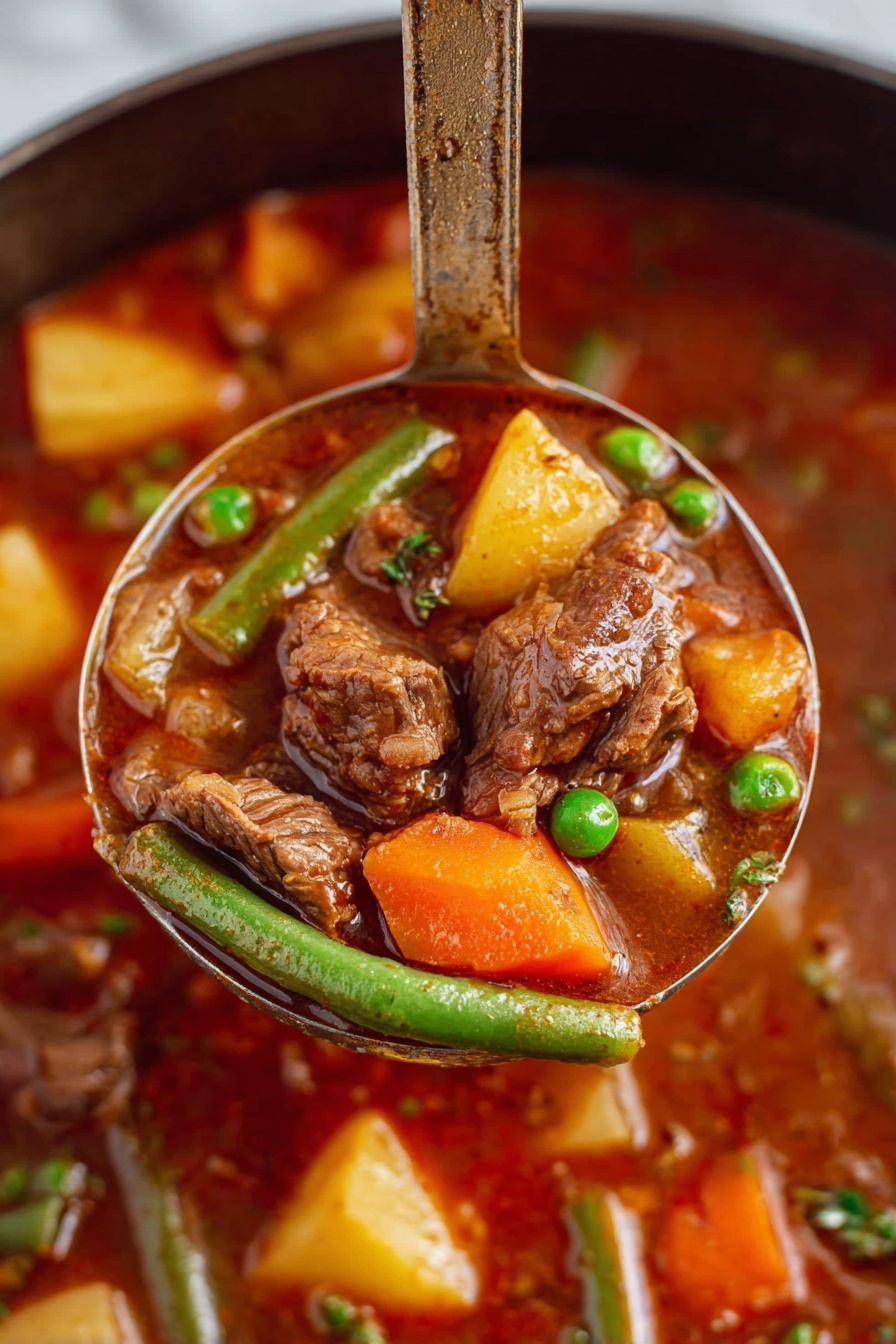 A close-up view of a ladle lifting a rich beef stew filled with soft brown chunks of beef, bright orange carrot pieces, yellow potato cubes, green beans, and green peas all mixed in a thick, deep reddish-brown broth. The background shows more of the stew with similar colorful vegetables and beef pieces visible. The ladle handle stands upright, emphasizing the hearty ingredients and texture of the dish. The scene is set on a white marbled surface. Photo taken with an iphone --ar 2:3 --v 7 - Vegetable Beef Stew, hearty beef stew recipe, comforting beef stew, homemade beef stew, tender beef vegetable stew