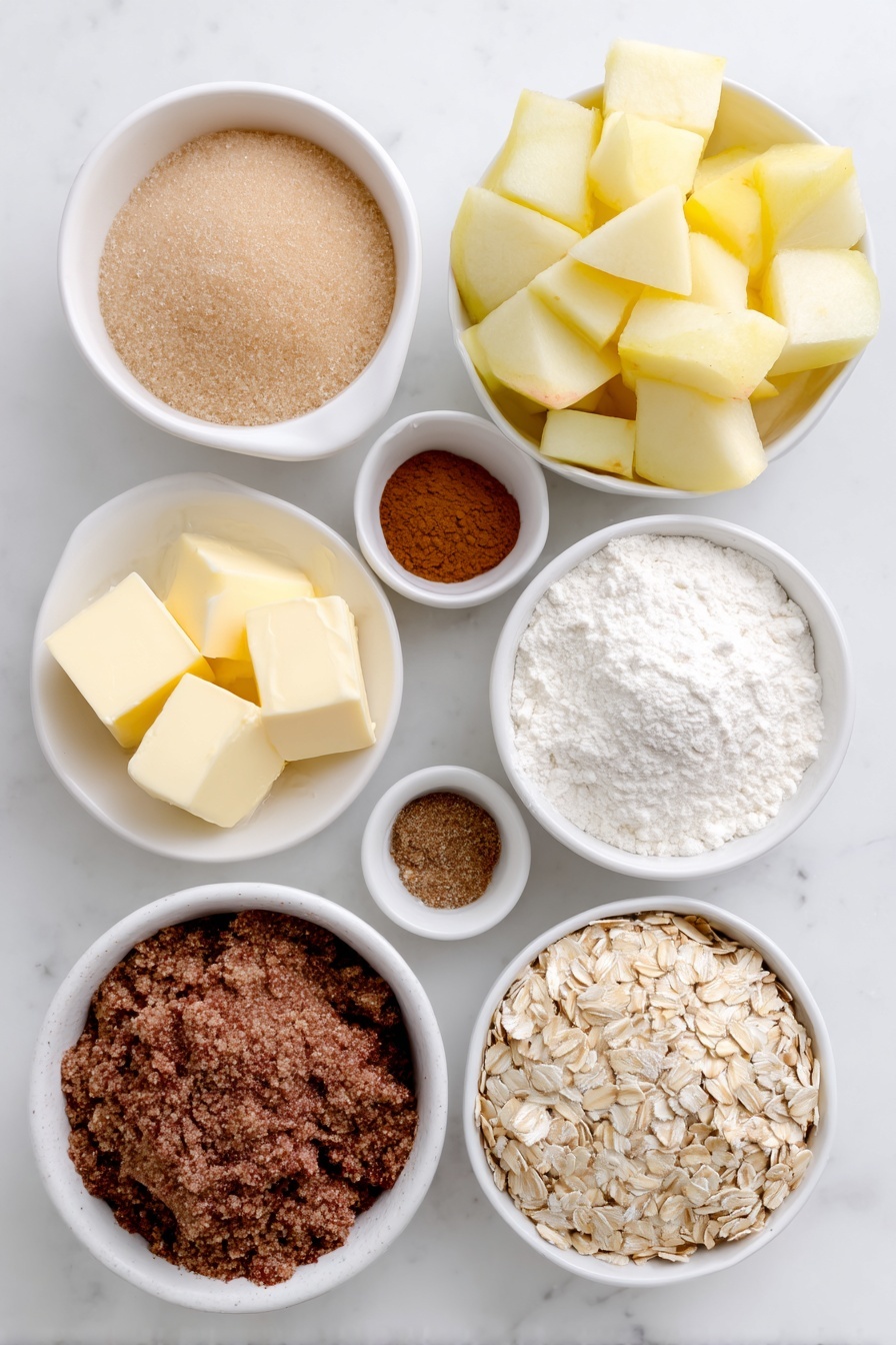 Flat lay of fresh peeled apple chunks with smooth pale yellow flesh, a small white ceramic bowl of packed light brown sugar, a small white ceramic bowl of all-purpose flour with fine white powder, a small white ceramic bowl of ground cinnamon with warm reddish-brown color, a small white ceramic bowl of ground nutmeg with medium brown color, a small white ceramic bowl of fine salt crystals, cold unsalted butter cut into neat cubes with a creamy pale yellow color arranged on a white ceramic plate, a small white ceramic bowl of old-fashioned whole rolled oats with natural beige flakes, and a small white ceramic bowl of pure vanilla extract liquid with pale golden hue, all arranged symmetrically on a clean white marble surface, soft natural light, photo taken with an iPhone, professional food photography style, fresh ingredients, white ceramic bowls, no bottles, no duplicates, no utensils, no packaging --ar 2:3 --v 7 --p m7354615311229779997 - Ultimate Apple Crisp, apple crisp dessert, cozy apple dessert, classic apple crisp recipe, easy apple crumble