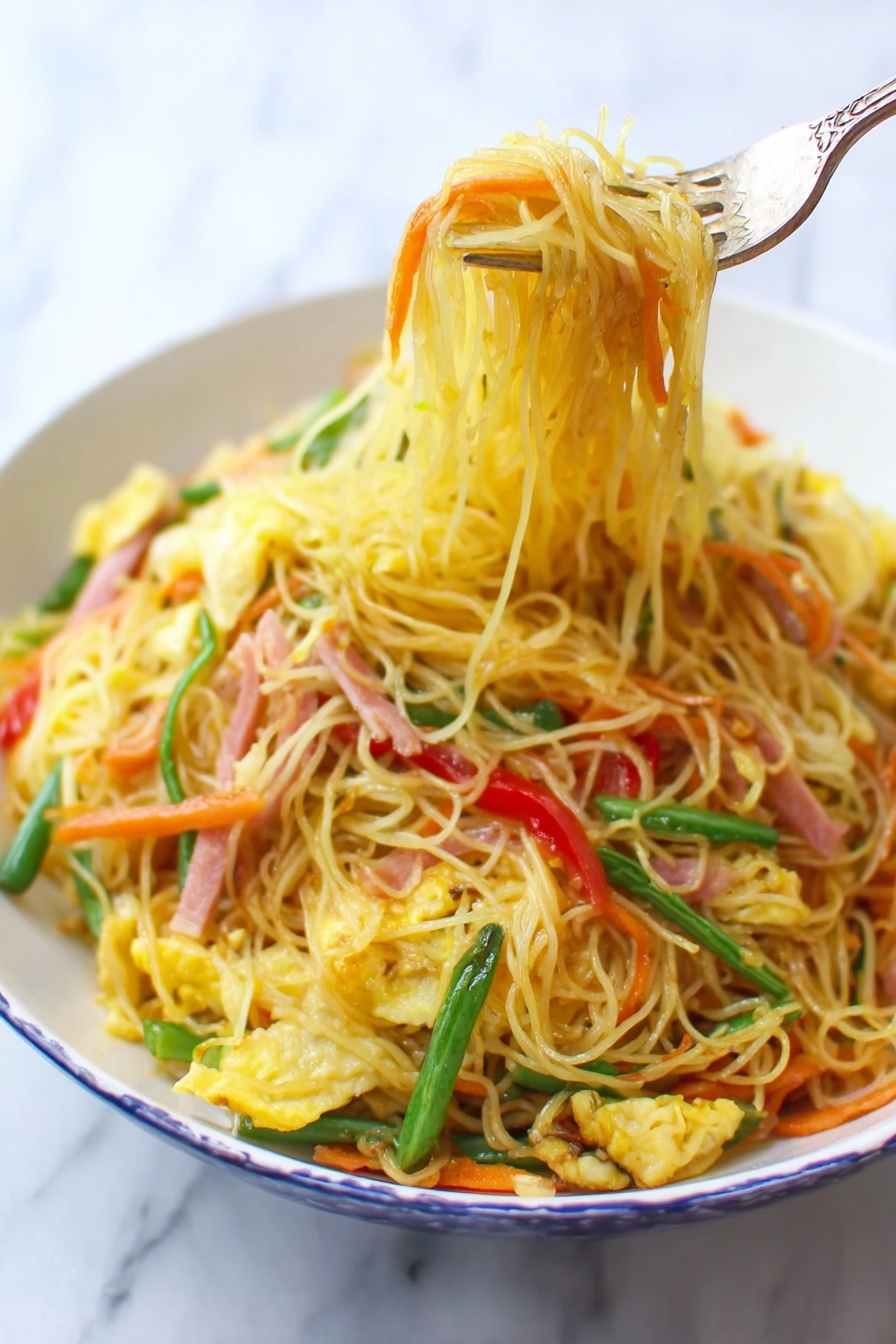 A white bowl filled with thin yellow noodles mixed with bright orange carrot strips, light green beans, red bell pepper slices, and small pieces of scrambled egg, all stirred together with thin strips of ham that have a light pink color. A fork lifts a bundle of noodles from the bowl, showing the textured and slightly oily surface of the noodles. The background is a white marbled surface. photo taken with an iphone --ar 2:3 --v 7 - Singapore Rice Noodles with Shrimp and Curry, Asian noodle stir-fry, shrimp curry rice noodles, quick Singaporean noodle dish, flavorful shrimp rice noodles