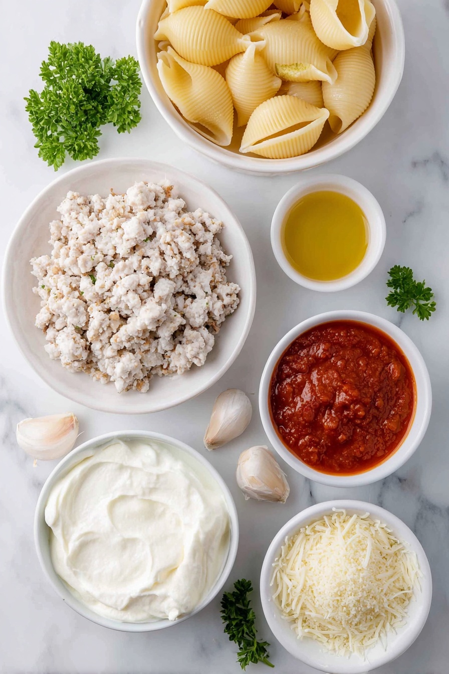 Flat lay of jumbo pasta shells arranged next to a small white bowl of olive oil, a mound of ground chicken pieces seasoned with dried Italian herbs and salt, a large white ceramic bowl filled with creamy whole milk ricotta cheese, a small white bowl holding shredded mozzarella cheese, another small white bowl with grated Parmesan cheese, one whole uncracked large egg with a clean shell, four peeled garlic cloves, a small white bowl containing vibrant red marinara sauce, a small white bowl of light golden Panko breadcrumbs, and a few fresh sprigs of chopped parsley scattered nearby, all placed on a clean white marble surface, soft natural light, photo taken with an iPhone, professional food photography style, fresh ingredients, white ceramic bowls, no bottles, no duplicates, no utensils, no packaging --ar 2:3 --v 7 --p m7354615311229779997 - Chicken Parmesan Stuffed Shells, Italian stuffed shells, baked chicken and pasta casserole, cheesy chicken stuffed shells, family dinner Italian recipes
