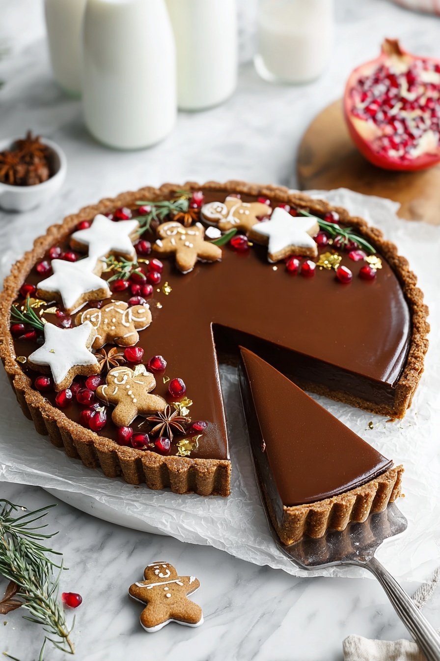A round tart with a brown crust and a smooth, shiny dark chocolate filling sits on a white marbled surface lined with white paper. Three slices are cut and partly lifted with a spatula showing the thick layers of crust and creamy chocolate inside. The top edge of the tart is decorated with white star-shaped cookies, small gingerbread men with white icing, brown star anise pieces, fresh green rosemary sprigs, scattered shiny red pomegranate seeds, and small gold leaf pieces. Two glass bottles of milk are blurred in the background on the white marbled surface. A partially opened pomegranate on a wooden board is also visible. Photo taken with an iphone --ar 2:3 --v 7 - Vegan Gingerbread Chocolate Tart, gingerbread chocolate tart, vegan holiday desserts, dairy-free chocolate tart, festive vegan desserts