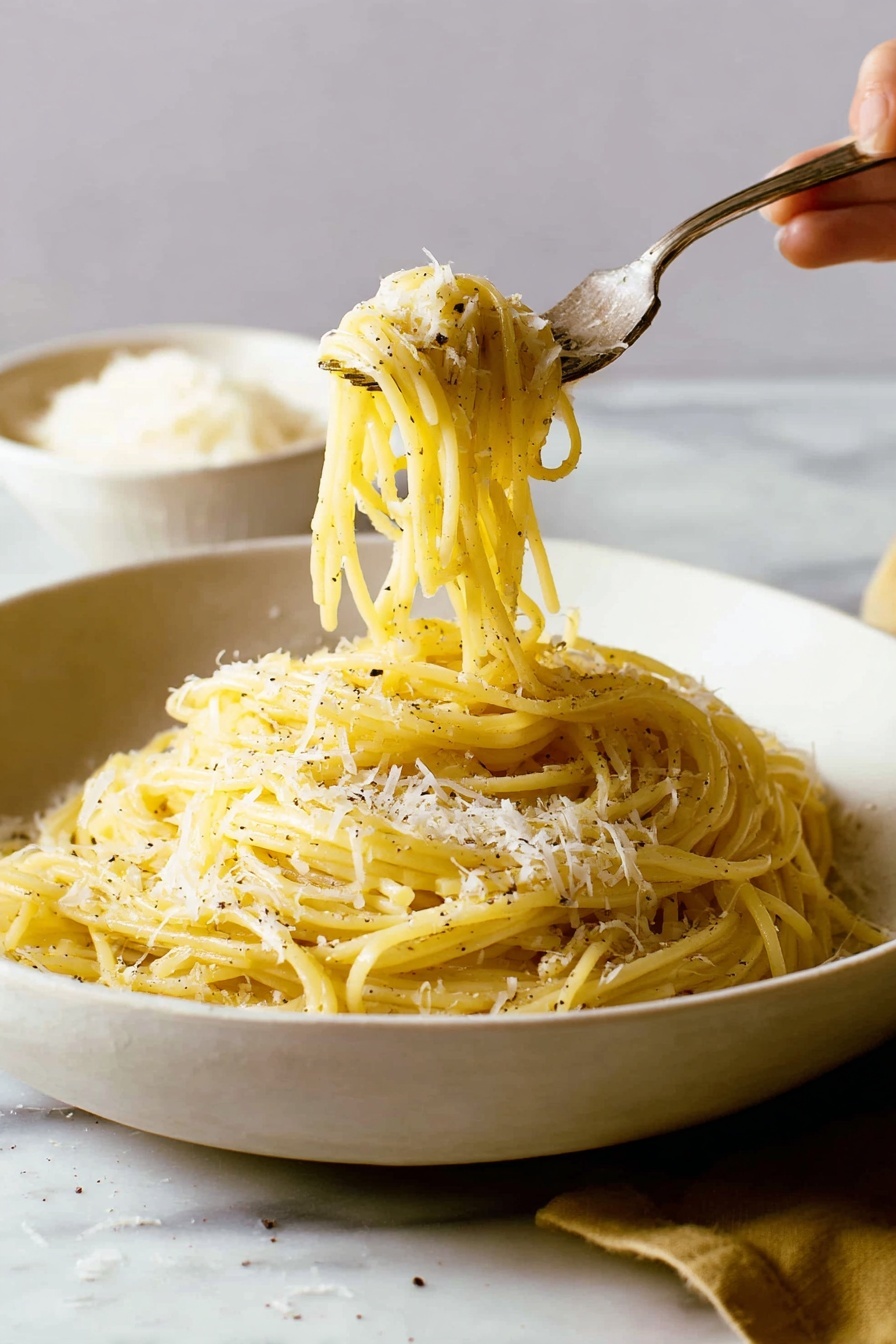 A white, shallow bowl filled with a pile of yellowish spaghetti pasta, sprinkled with small patches of grated white cheese and black pepper. The pasta strands have a smooth and slightly shiny texture, twisted around a silver fork that a woman's hand is lifting from the bowl. The background and surface around the bowl have a white marbled texture, with a blurred white bowl of grated cheese in the back left side. The scene is softly lit, showing a warm and cozy feel. photo taken with an iphone --ar 2:3 --v 7 - Easy Cacio e Pepe Pasta, simple Italian pasta dish, quick pasta recipes, beginner-friendly pasta, authentic Cacio e Pepe