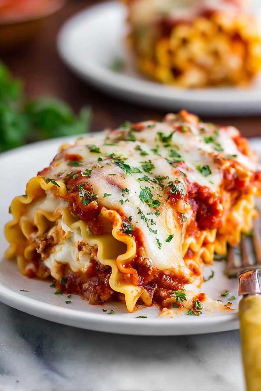 A white rectangular baking dish holds a freshly baked layered lasagna with a thick top layer of melted cheese browned unevenly with golden and white spots. The surface is sprinkled with small green herb leaves. The lasagna appears rich and textured, with visible layers of savory sauce under the cheese. The dish sits on a smooth white marbled surface. photo taken with an iphone --ar 2:3 --v 7 - Cheesy Beef Lasagna Roll Ups, beef lasagna roll ups, cheesy lasagna roll ups, easy lasagna roll ups, savory beef pasta roll ups