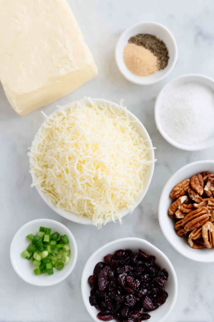 Flat lay of a block of full-fat cream cheese softened, a small heap of shredded sharp white cheddar cheese, a few sprigs of chopped fresh green onions, a small white bowl of light brown sugar, a small white bowl of garlic powder, a small white bowl of fine salt, a small white bowl of ground black pepper, a small white bowl of finely chopped dried cranberries, and a small white bowl of finely chopped pecans, all arranged in perfect symmetry on a clean white marble surface, soft natural light, photo taken with an iPhone, professional food photography style, fresh ingredients, white ceramic bowls, no bottles, no duplicates, no utensils, no packaging --ar 2:3 --v 7 --p m7354615311229779997 - Cranberry Pecan Cheese Ball, holiday cheese ball appetizer, creamy cheese ball with cranberries, easy festive cheese ball recipe, crowd-pleasing holiday appetizer