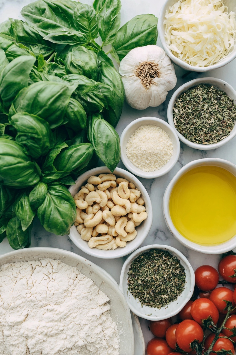 Flat lay of fresh bright green basil leaves and a few sprigs of mixed leafy herbs, a small pile of raw Australian macadamia nuts, two whole uncracked garlic cloves, a small white bowl of golden extra virgin olive oil, a small white bowl of nutritional yeast flakes, a small white bowl of lemon juice, a small white bowl of coarse sea salt, a mound of smooth all-purpose flour, a small white bowl of warm dairy-free milk, a chunk of soft vegan butter, a small white bowl of granulated sugar, a small white bowl of instant dry yeast granules, a small white bowl of mixed dried herbs, a scattering of whole and crushed raw macadamia nuts, and a handful of glossy red cherry tomatoes, all arranged with perfect symmetry on a clean white ceramic plate and in simple white ceramic bowls, placed on a clean white marble surface, soft natural light, photo taken with an iPhone, professional food photography style, fresh ingredients, white ceramic bowls, no bottles, no duplicates, no utensils, no packaging --ar 2:3 --v 7 --p m7354615311229779997 - Vegan Pesto Bread Wreath, vegan bread recipes, vegan appetizer ideas, plant-based bread art, festive vegan bread wreath