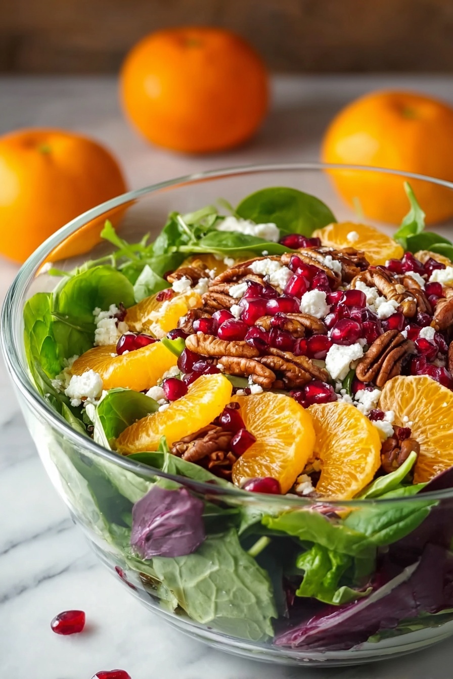A clear glass bowl is filled with a colorful layered salad. The bottom layer is fresh green spinach and mixed greens with some purple leaves scattered in. On top, bright orange mandarin slices are placed evenly, along with deep red pomegranate seeds scattered around. There are also brown pecan halves spread throughout. Small white crumbles of cheese are sprinkled over the top, adding contrast. The bowl sits on a white marbled surface with two whole mandarins blurred softly in the background. The image has a natural light setting, highlighting the fresh and vibrant colors of the salad. Photo taken with an iphone --ar 2:3 --v 7 - Festive Orange Pomegranate Salad, citrus fruit salad, holiday fruit salad, Christmas side dish, easy holiday salad