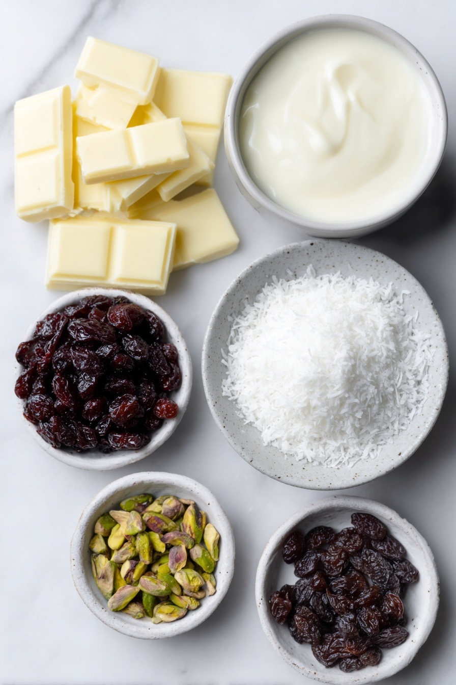 Flat lay of a small pile of chopped white chocolate pieces, a small white ceramic bowl filled with thickened cream, a tiny white bowl holding glossy vanilla bean paste, a small white bowl containing chopped dried cranberries, a small white bowl with chopped pistachios, and a shallow white ceramic dish with fine desiccated coconut arranged neatly beside them, all ingredients fresh and natural, placed on a clean white marble surface, soft natural light, photo taken with an iPhone, professional food photography style, fresh ingredients, white ceramic bowls, no bottles, no duplicates, no utensils, no packaging --ar 2:3 --v 7 --p m7354615311229779997 - White Chocolate Cranberry Pistachio Truffles, holiday chocolates, festive truffles, easy homemade truffles, holiday treat ideas