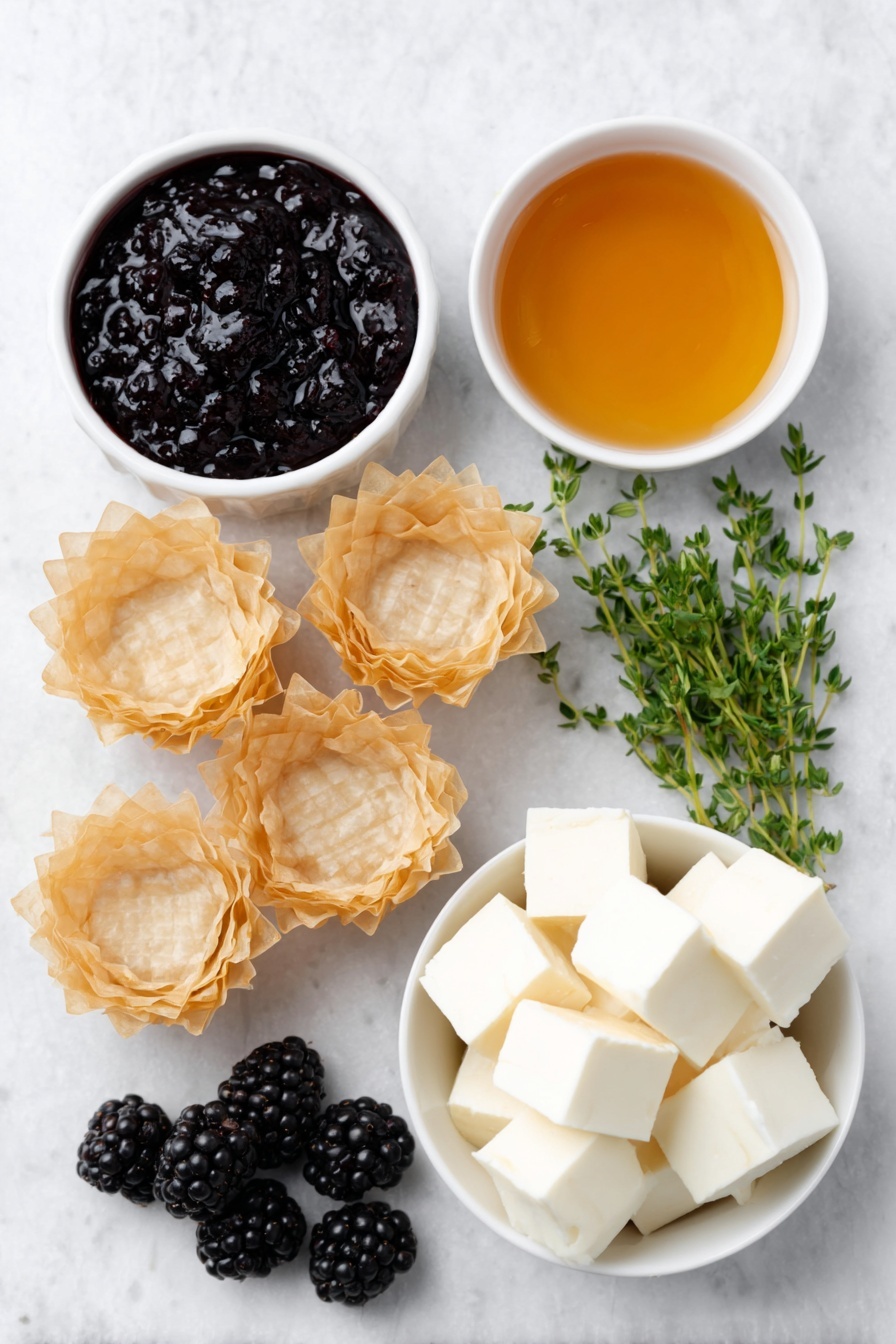 Flat lay of fresh golden mini phyllo shells arranged neatly, a small white ceramic bowl with glossy deep purple blackberry jam, another small white bowl filled with clear golden honey, creamy pale off-white cubes of brie cheese without rind, a handful of plump fresh blackberries with a rich dark purple hue, and a few sprigs of vibrant green fresh thyme artfully placed, all ingredients balanced symmetrically and naturally placed on a clean white marble surface, soft natural light, photo taken with an iPhone, professional food photography style, fresh ingredients, white ceramic bowls, no bottles, no duplicates, no utensils, no packaging --ar 2:3 --v 7 --p m7354615311229779997 - Brie Blackberry Phyllo Cups, easy appetizer ideas, elegant party appetizers, fruit and cheese bites, baked brie appetizers