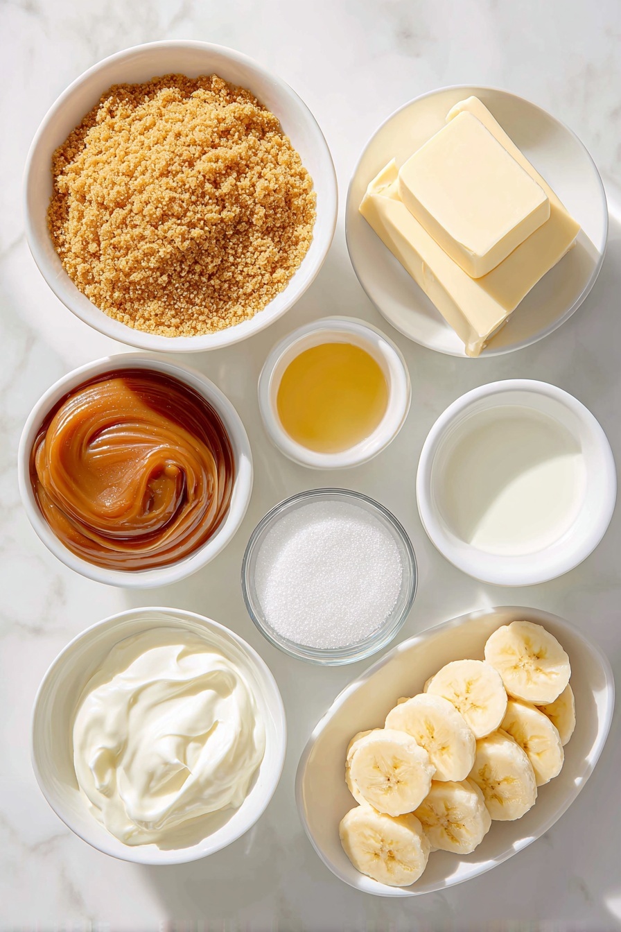 Flat lay of finely crushed golden-brown graham cracker crumbs in a simple white ceramic bowl, a small white bowl of granulated sugar sparkling under natural light, a small white bowl holding melted golden unsalted butter, a small white bowl filled with smooth, glossy caramel-colored dulce de leche, two fresh ripe bananas sliced into neat, even rounds arranged in a small pile, a small white bowl of cold heavy cream, a small white bowl of fine confectioners’ sugar sparkling softly, and a small white bowl containing clear, pale vanilla extract, all arranged in perfect symmetry and balanced proportions, placed on a clean white marble surface, soft natural light, photo taken with an iPhone, professional food photography style, fresh ingredients, white ceramic bowls, no bottles, no duplicates, no utensils, no packaging --ar 2:3 --v 7 --p m7354615311229779997 - Banoffee Pie with Dulce de Leche and Bananas, easy banana dessert, British pie recipe, caramel banana tart, no-bake dessert